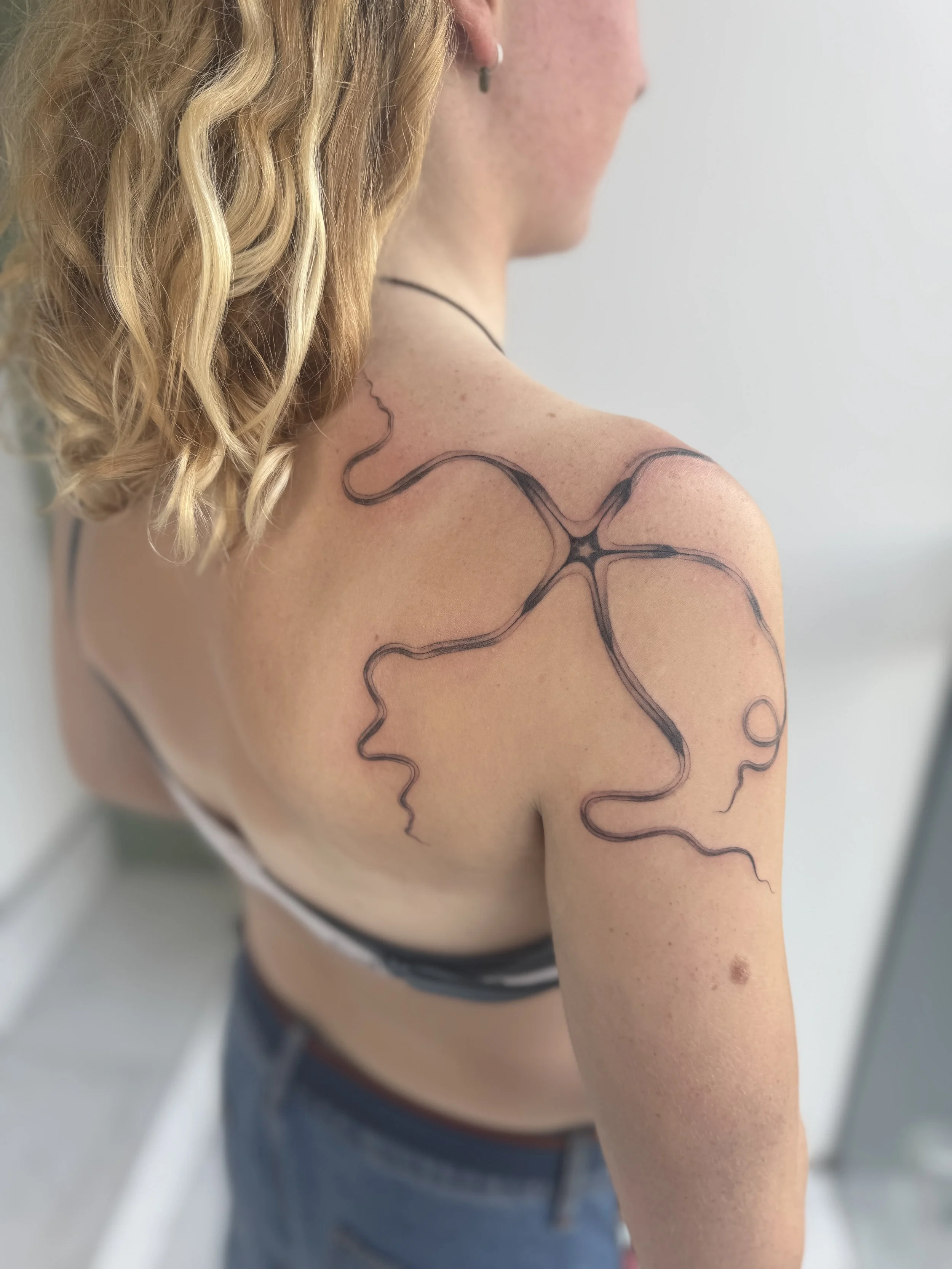 Custom sea urchin abstract shoulder tattoo with flow elements