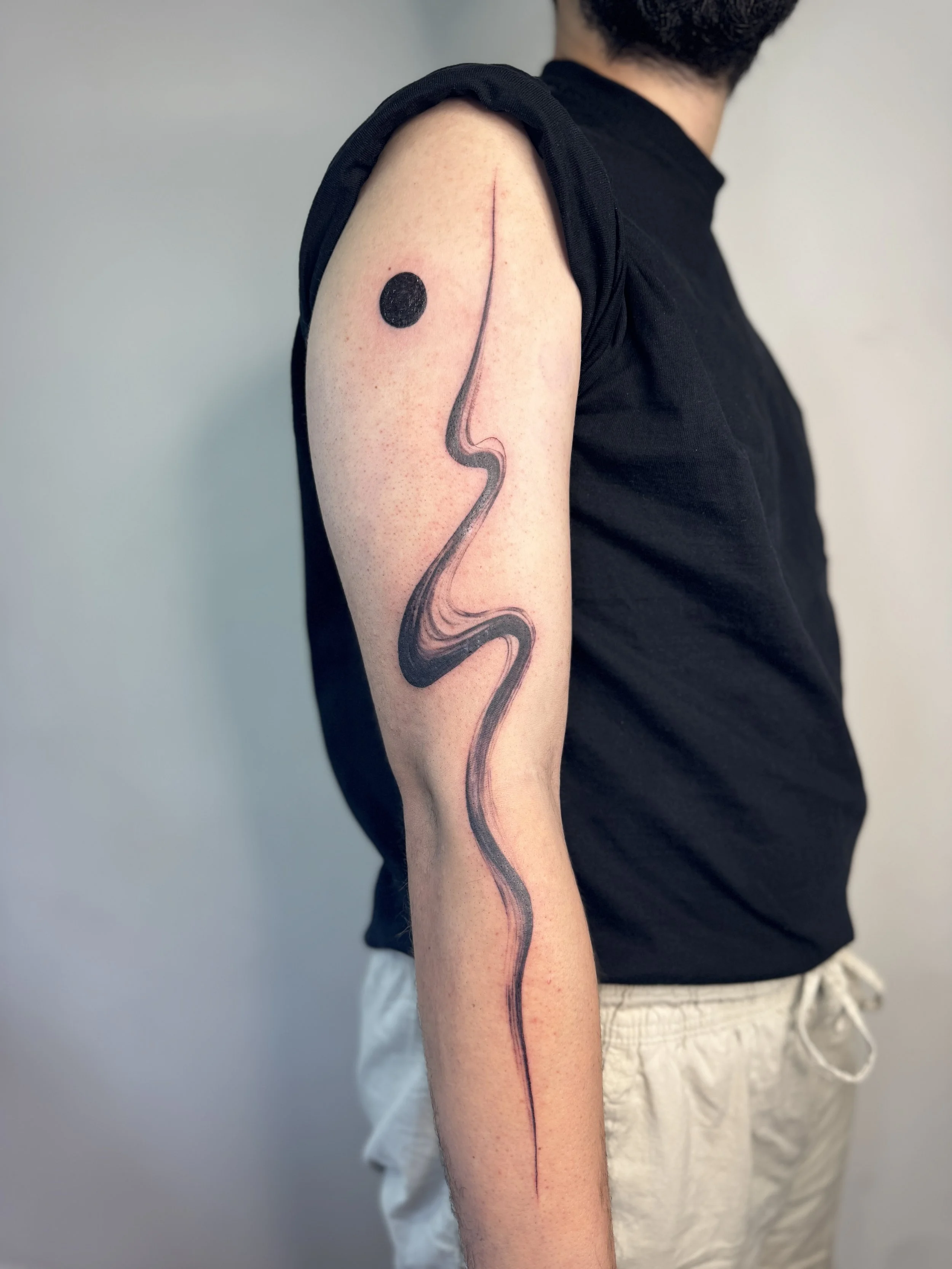 abstract brush stroke tattoo on a fun arm length. done in Vancouver, BC