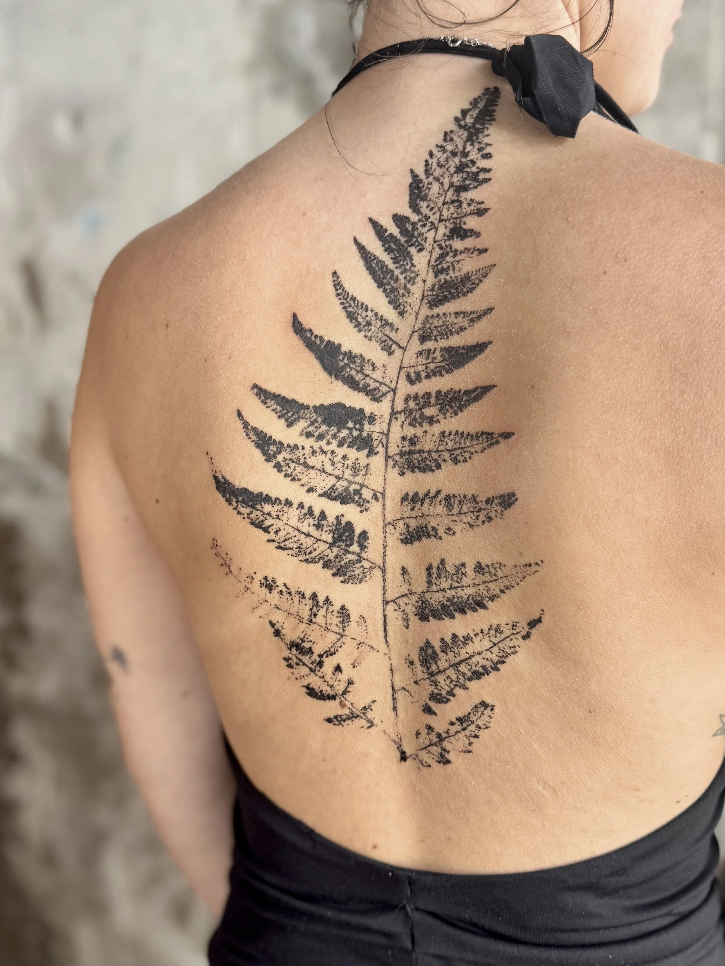 Organic fern leaf imprint tattoo with minimalist composition, tattoo artist Vancouver