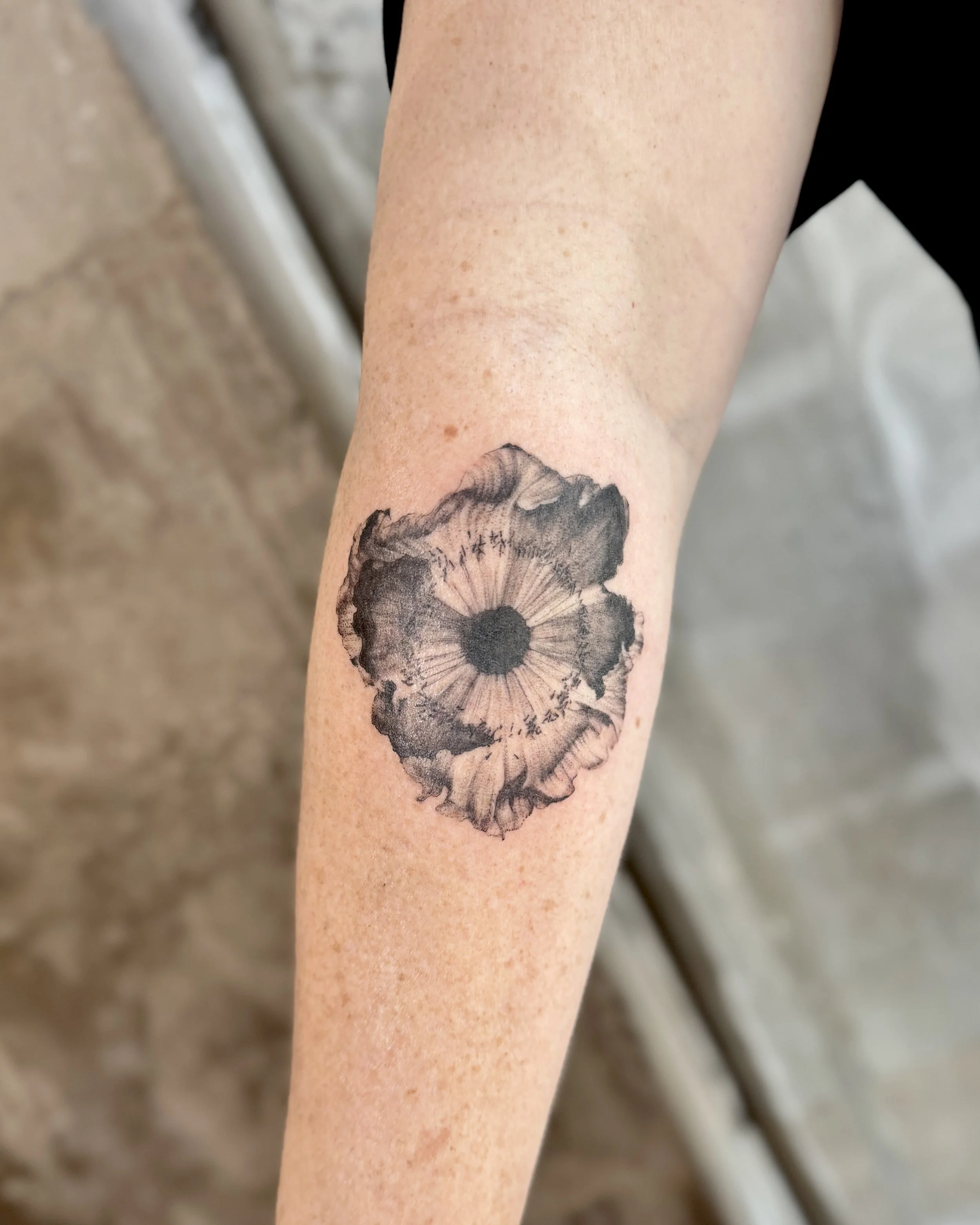 Abstract tattoo of a poppy flower ink drawing style. Blackwork tattoo artist
