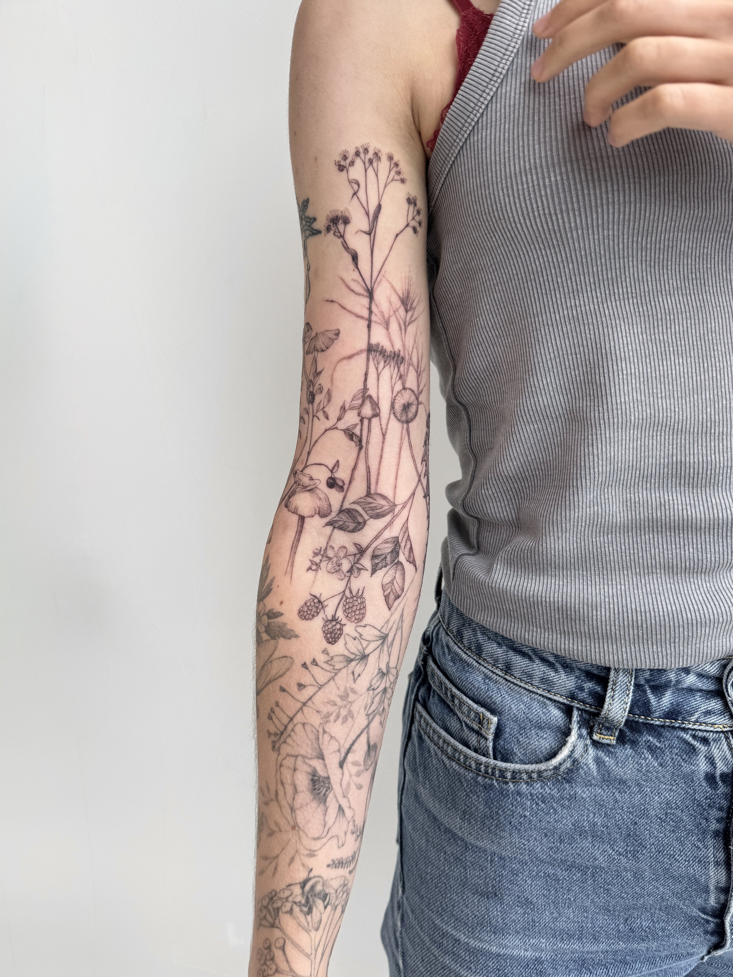 Organic abstract tattoo design with minimalist linework, Vancouver based tattoo artist. Fineline botanical composition with multiple soft flowers
