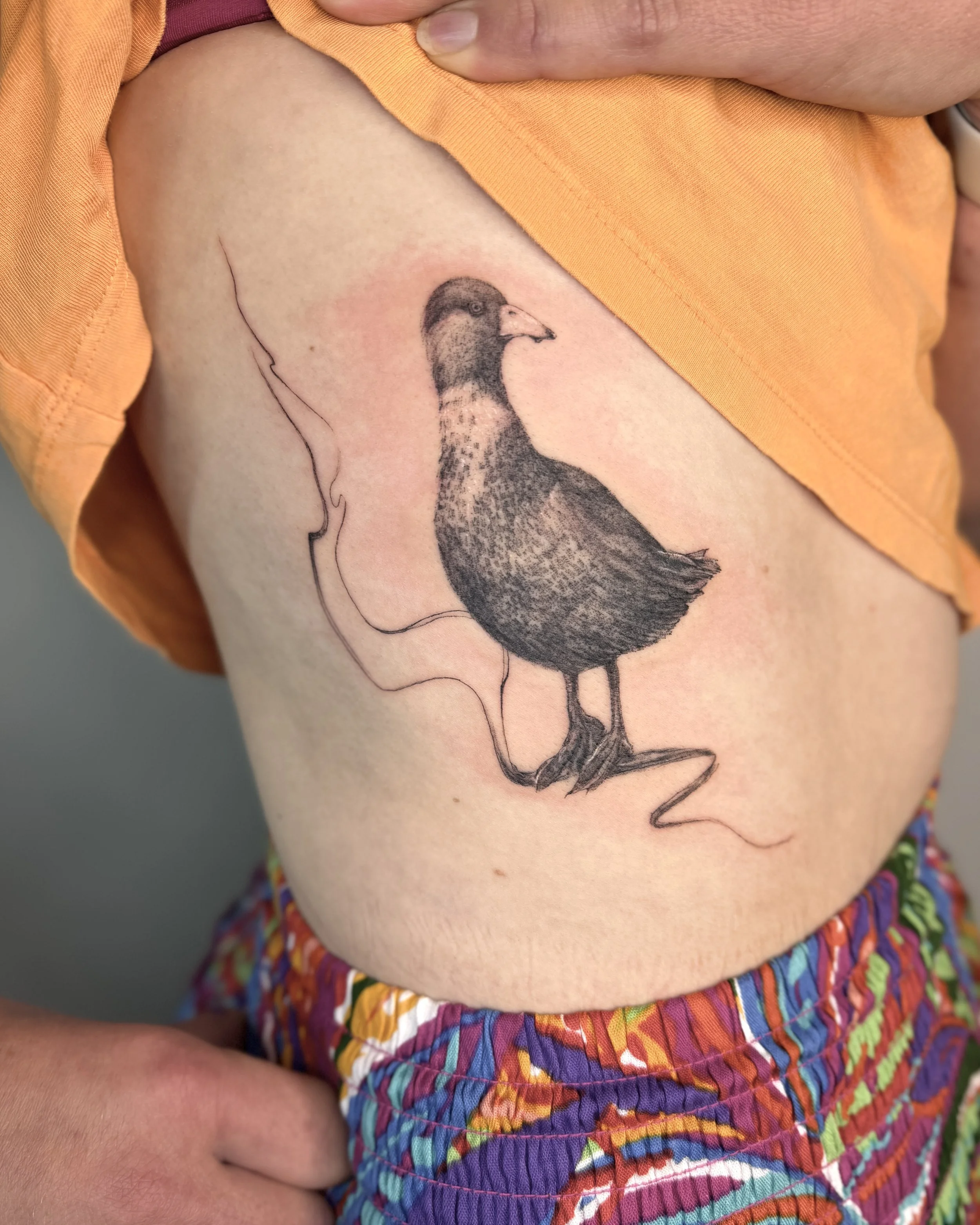 Duck micro realism tattoo with abstract elements. Tattoo detail highlighting organic flow and minimalist composition