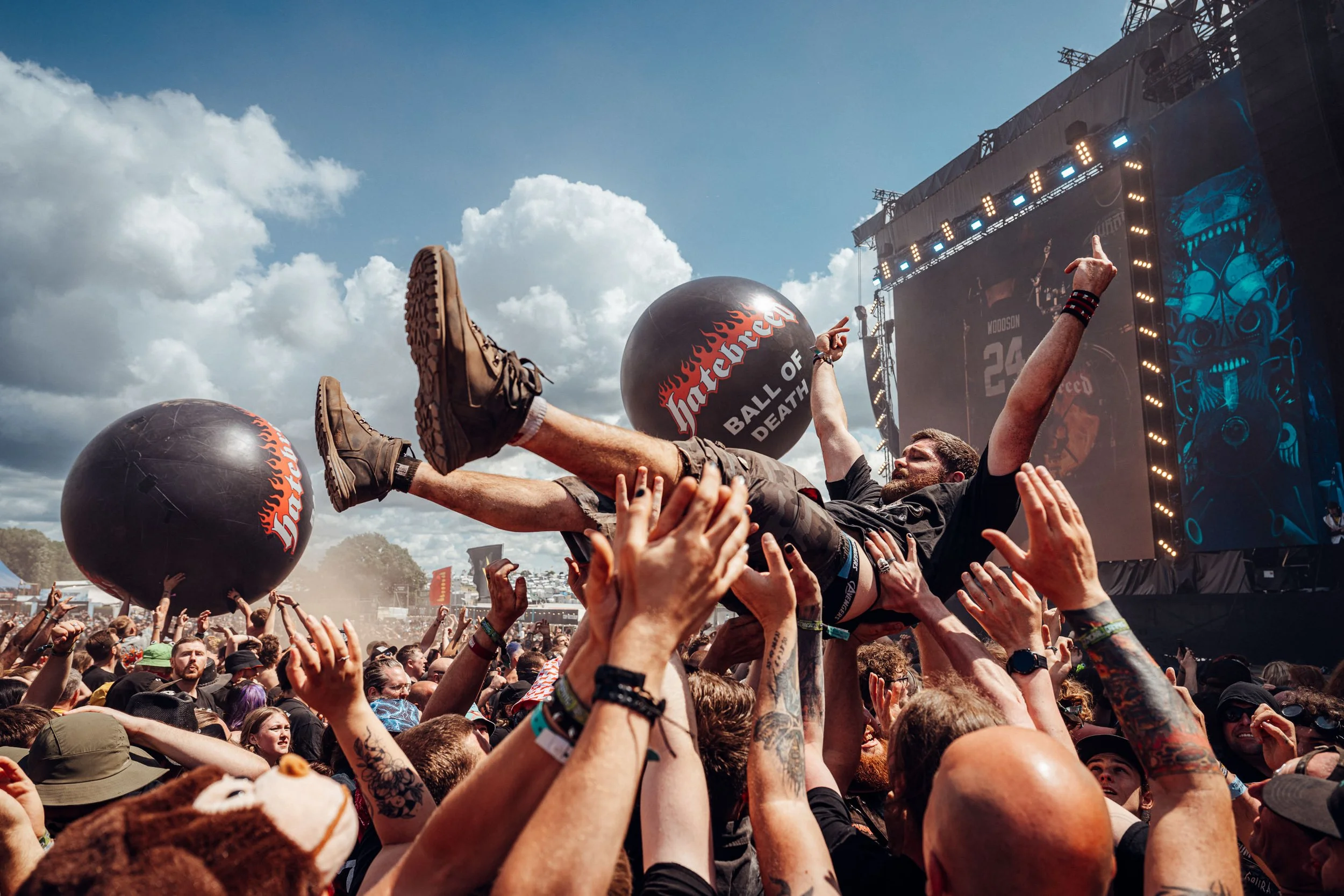 Download Festival MainStage - A festival goer crowd surfing being held up by many hands.