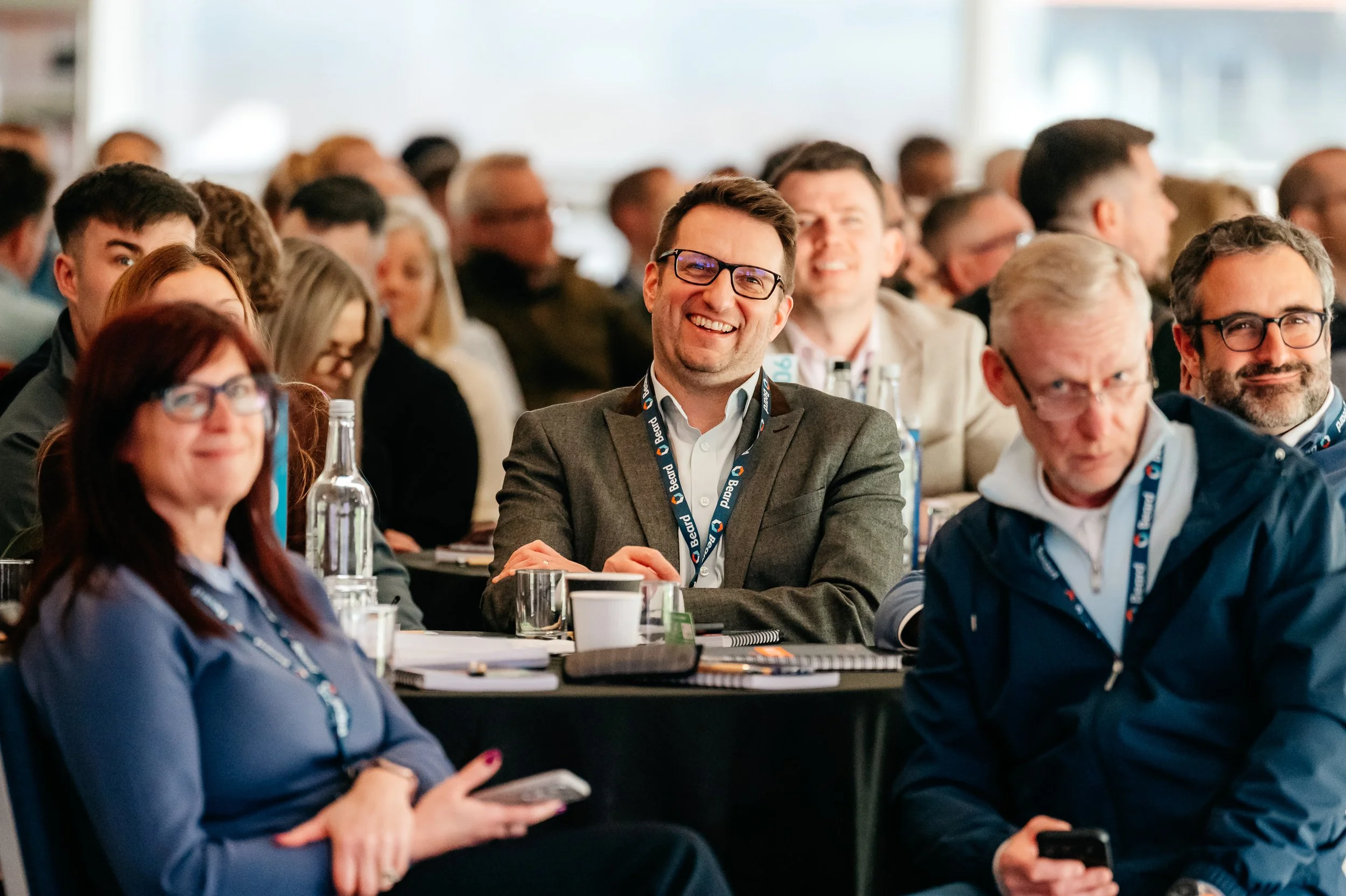 Gentleman seated and smiling during a conference for Beard Construction