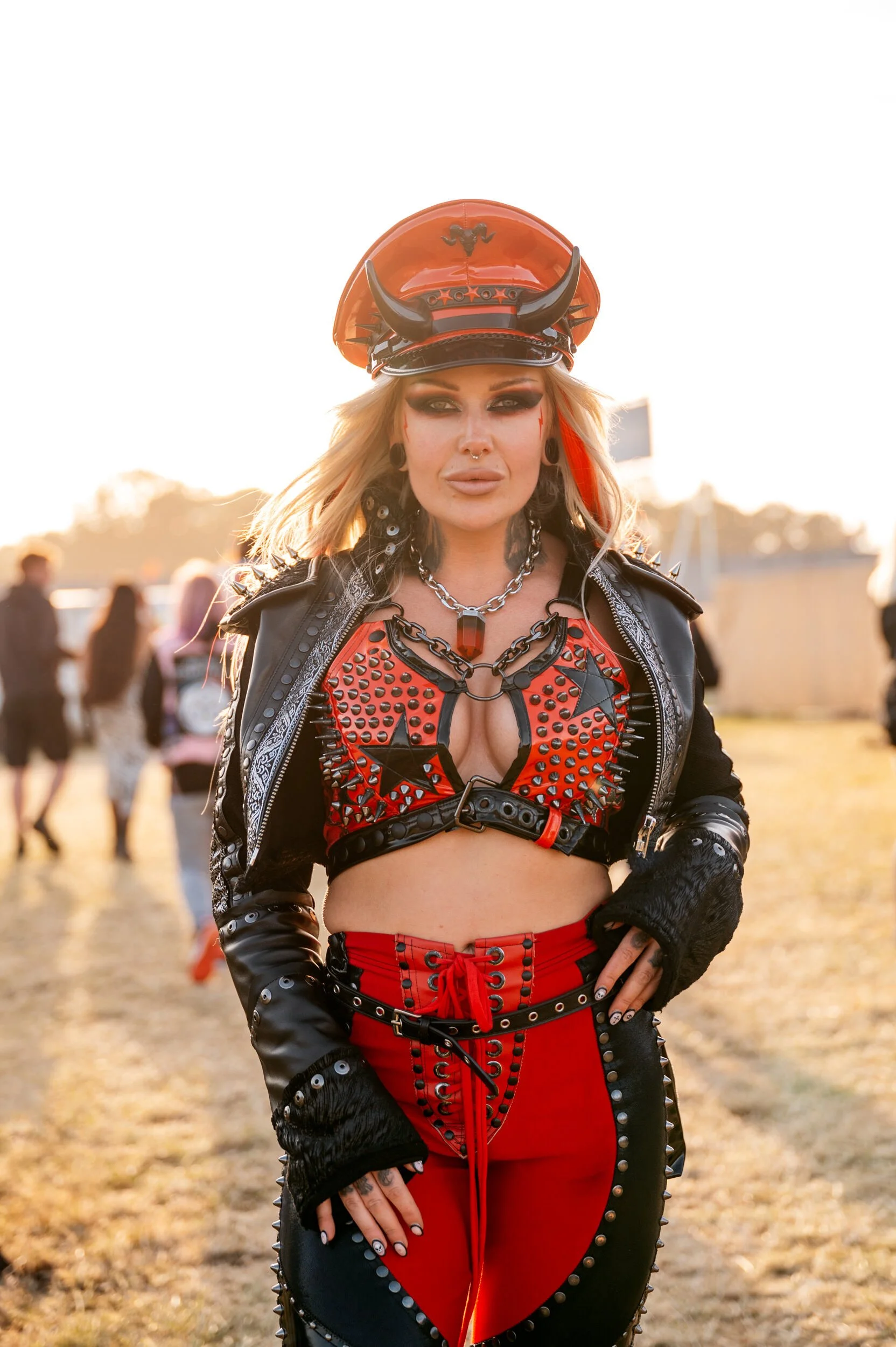 Download 2023 showing a woman dressed up in Red & Black leather taken by James Bridle Photography 