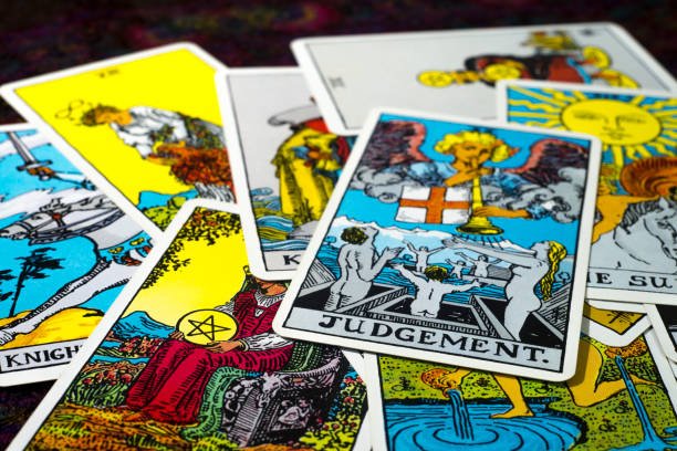 A spread of tarot cards with various colorful illustrations and symbols.
