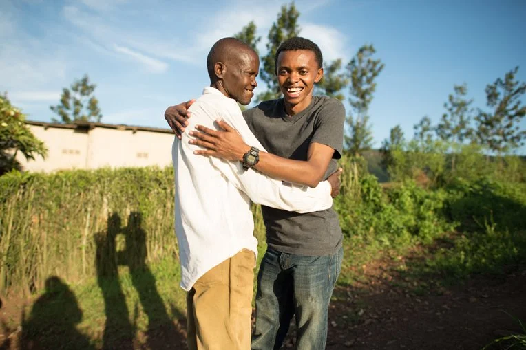 Alex spending a moment with his surviving uncle who cared for Alex and his siblings during the opening days of the Rwandan Genocide