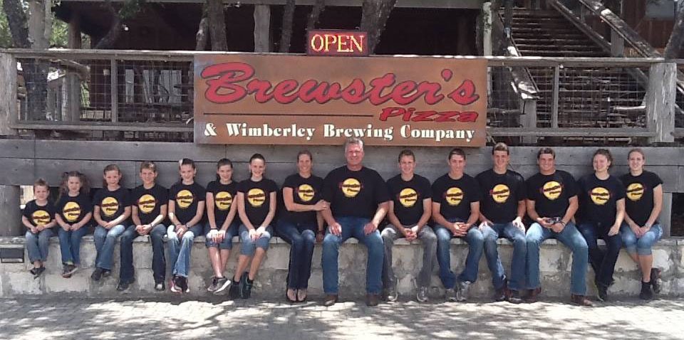 Bruce Collie and family in front of Brewster's Pizza