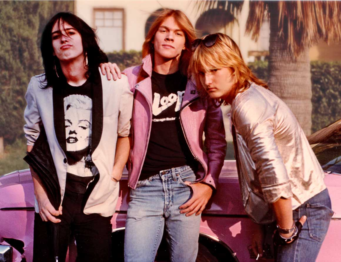 earliest photos of Guns N' Roses that were taken by Dean. They were randomly walking down the street when they saw the pink car that matched Axl's jacket.