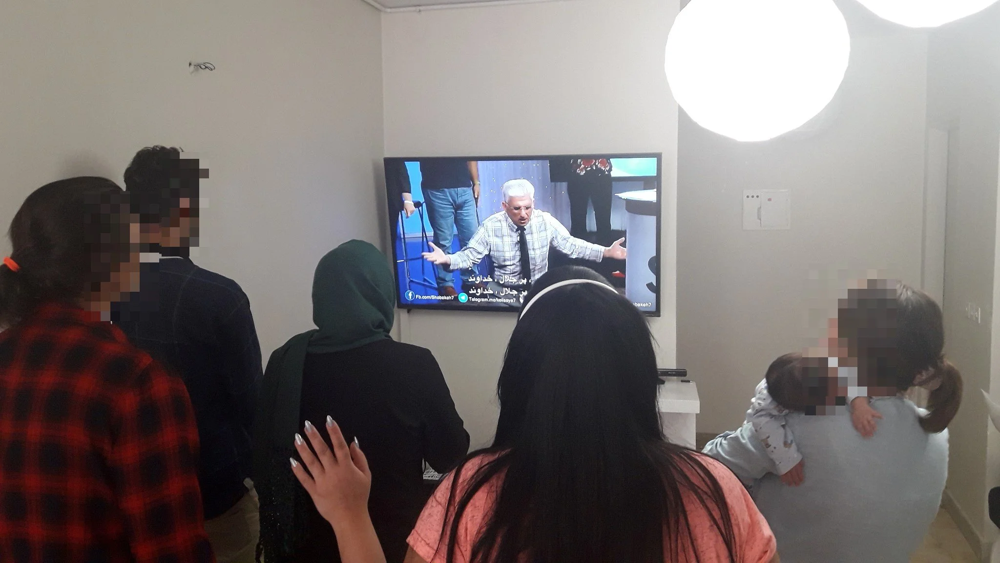 Iranians secretly worshipping in a home