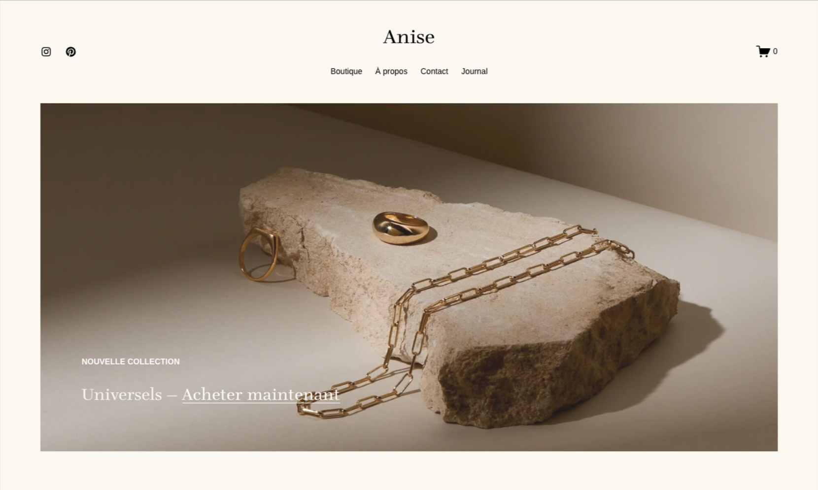 Une page web de boutique de bijoux intitulée 'Anise' présentant des bijoux en or, avec un collier, une bague et une broche posés sur une roche.