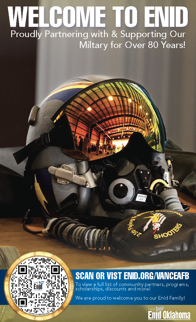 A helmet with sunglasses reflective visor, along with a headset and a patch that reads "Shooting Sports Shooters" placed on a table. The background of the visor shows an indoor shooting range. Text at the top reads "Welcome to ENID", celebrating over 80 years of military support. A QR code and a blue banner at the bottom invite viewers to visit enid.org/vanceafb for community information, with logos for City of Enid Oklahoma.