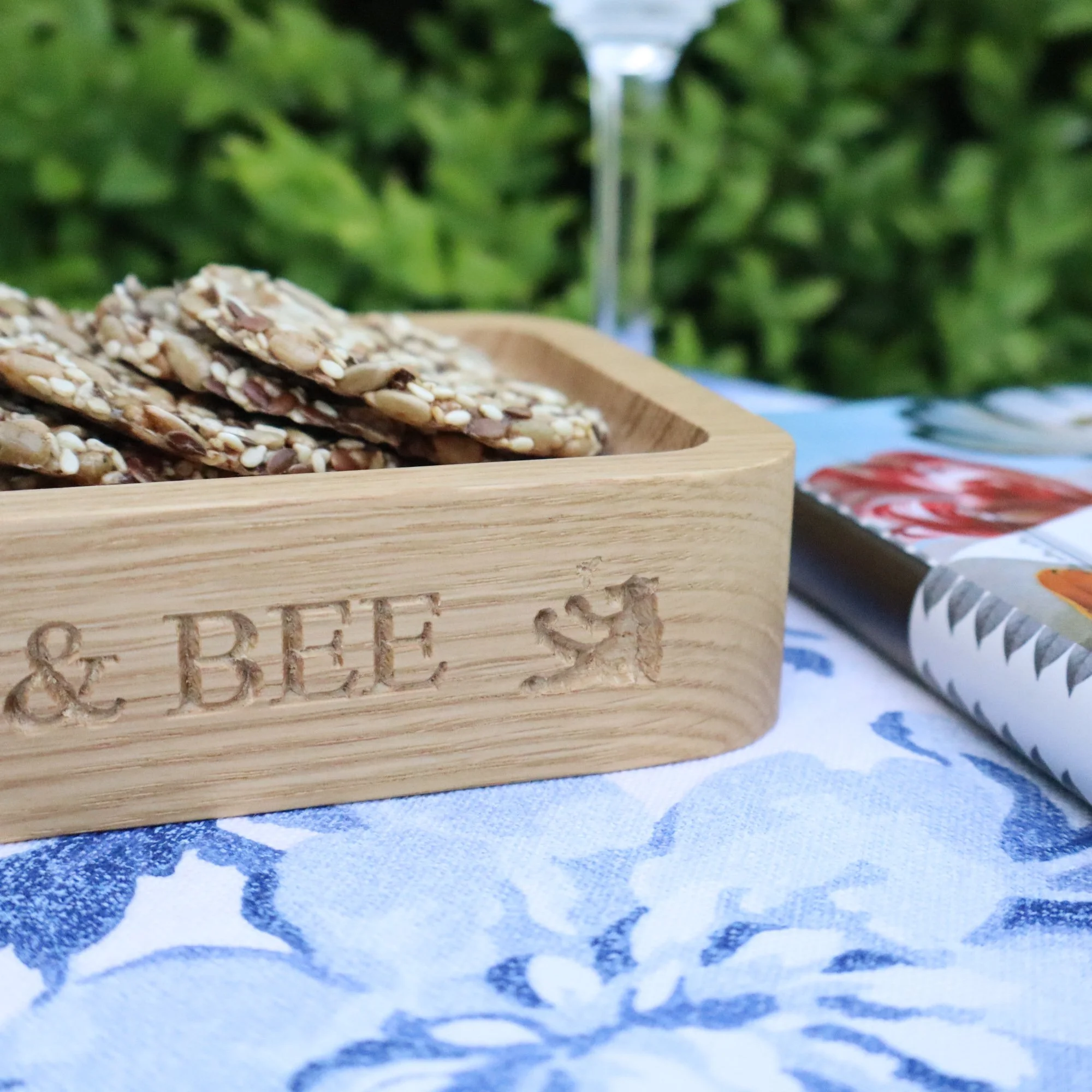 A close up of an engraved section of a solid oak tray showing the quality of the British craftsmanship.