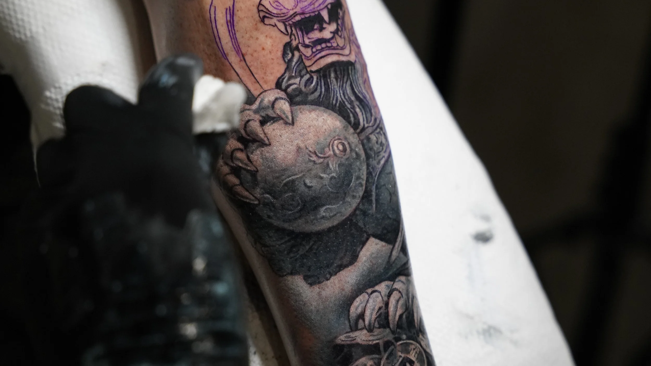 Close-up of a black and grey realism tattoo in progress at Black Nova Tattoo Collective in Miami, highlighting intricate shading and custom tattoo artistry.