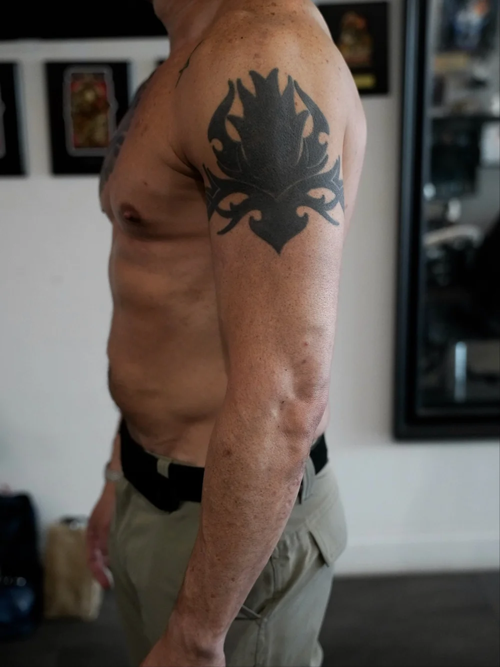 Original solid black tribal tattoo on the upper arm before a Japanese sleeve cover-up