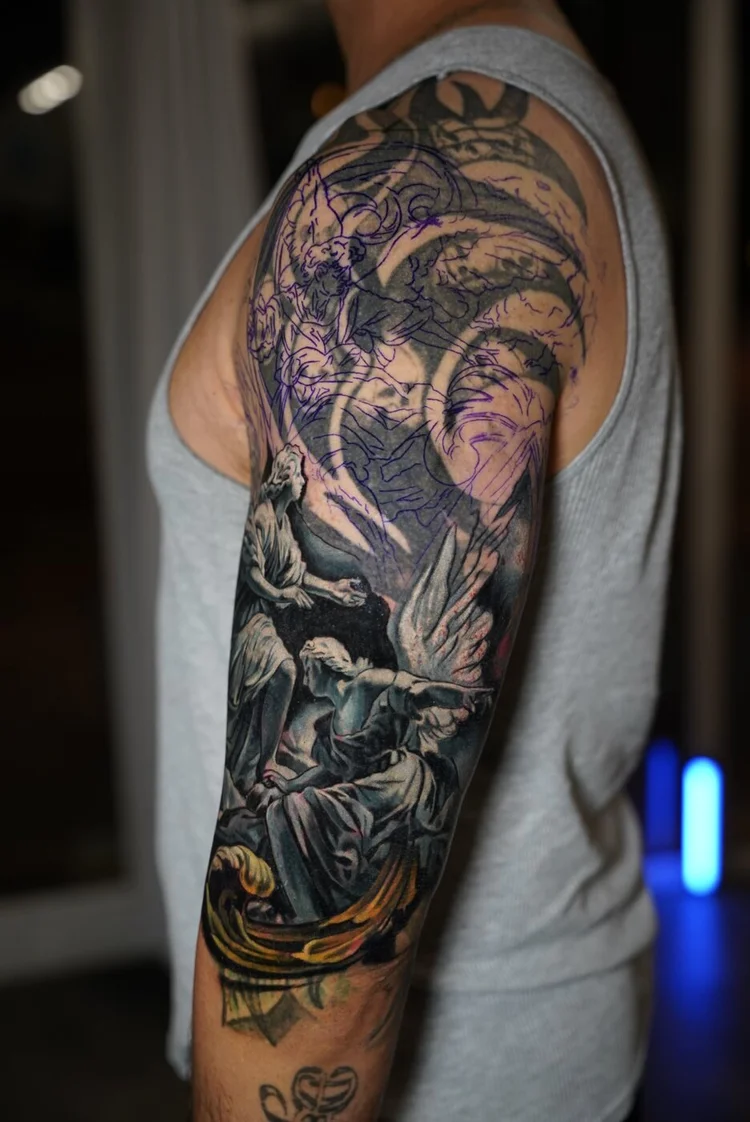 Angel cover-up on the upper arm after session one of the first layer.