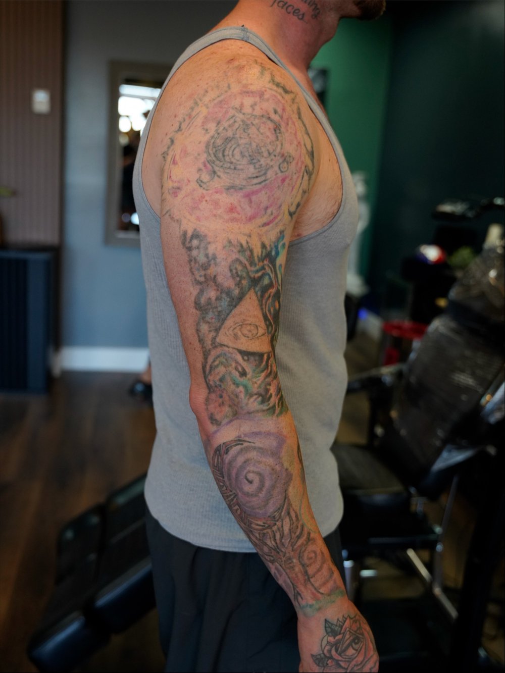 Faded full-arm tattoo before a Greek mythology cover-up