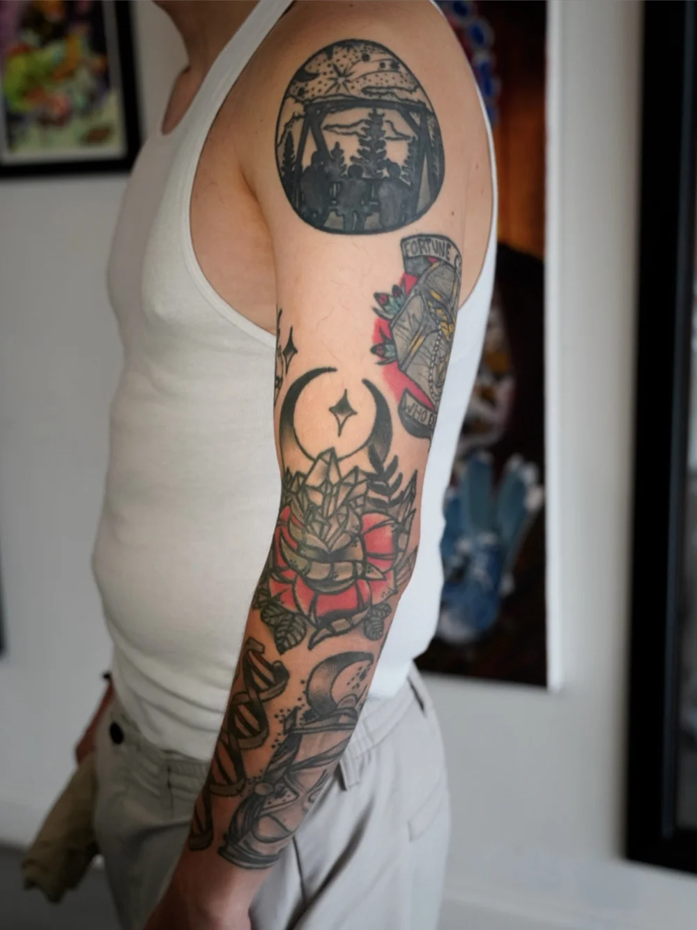 Separate traditional tattoos on the arm before a full sleeve cover-up
