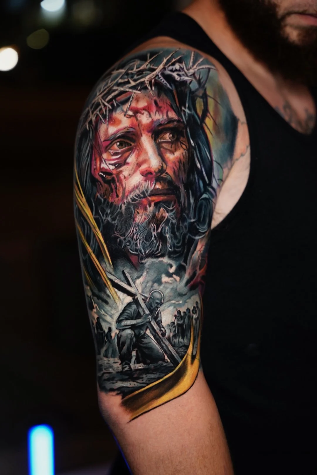 Emotional realism tattoo inspired by religious iconography. Detailed portrait work combined with narrative depth, dramatic lighting, and seamless transitions across the arm.
