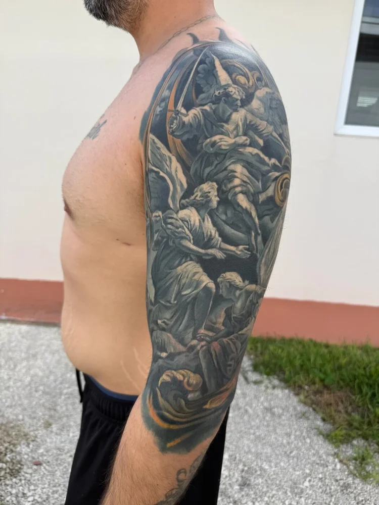 Client daylight photo of the angel upper-arm cover-up healed for about two months.
