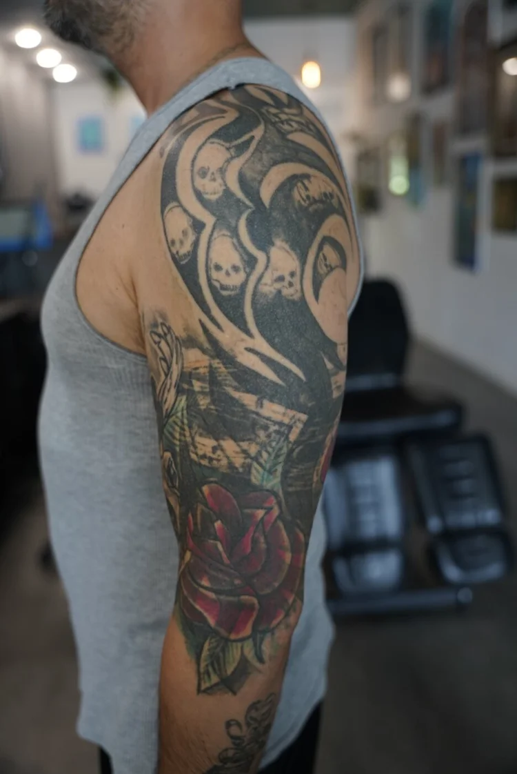 Ten-year-old tribal and floral tattoo on the upper arm before the angel cover-up.