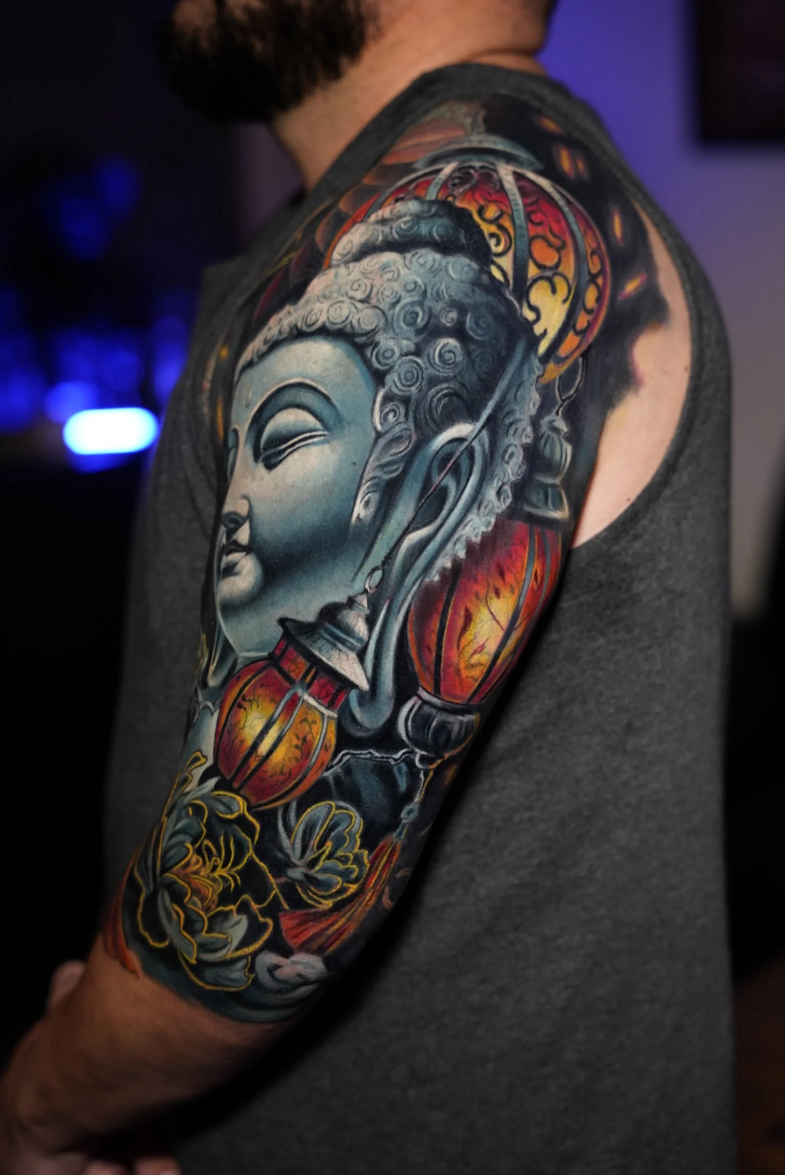 Color realism tattoo featuring a serene Buddha portrait with warm accent tones. Designed to contrast with surrounding elements while preserving harmony within the sleeve.