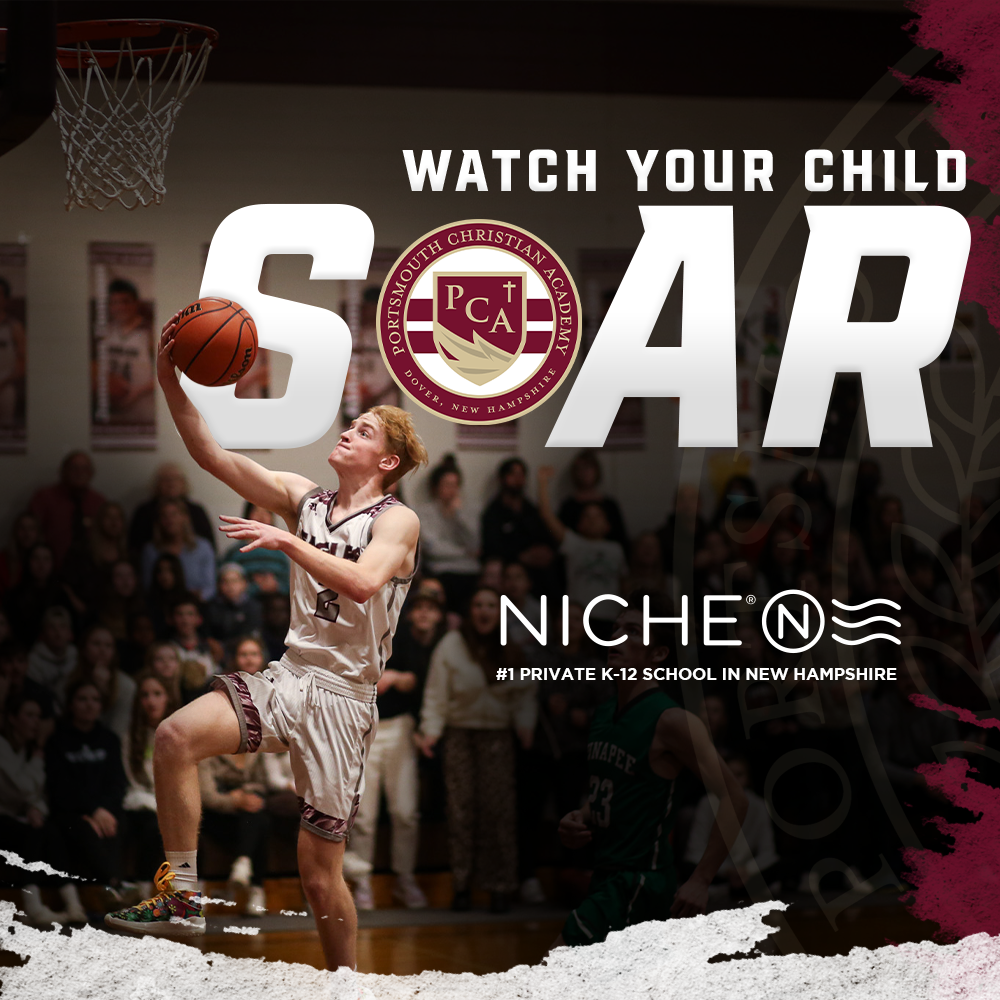A young basketball player in a white uniform jumping to shoot a basketball in an indoor gym, with an audience in the background and a basketball hoop above.