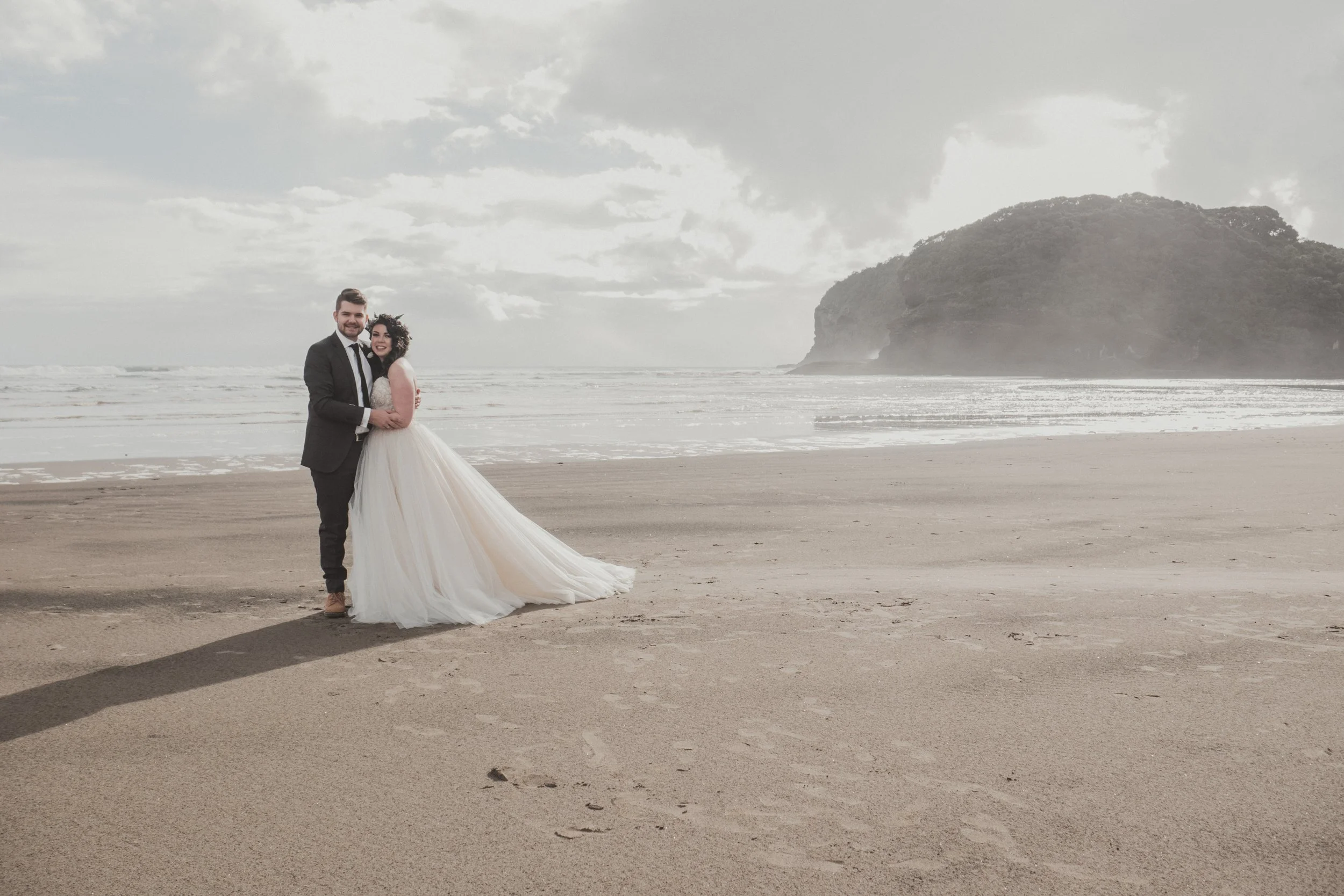 Banner image of a recently married couple on a beach.