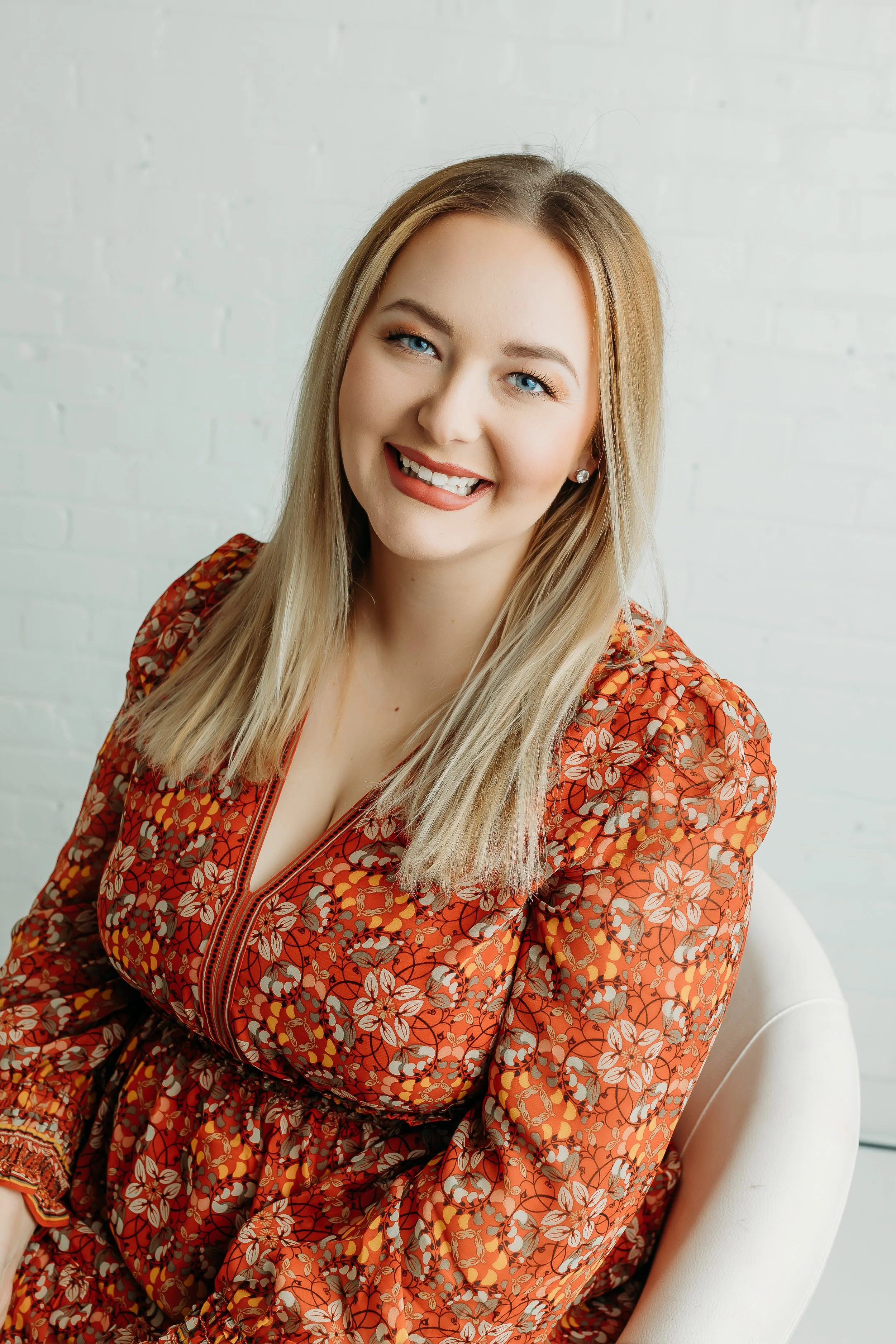 Author sitting in a chair smiling