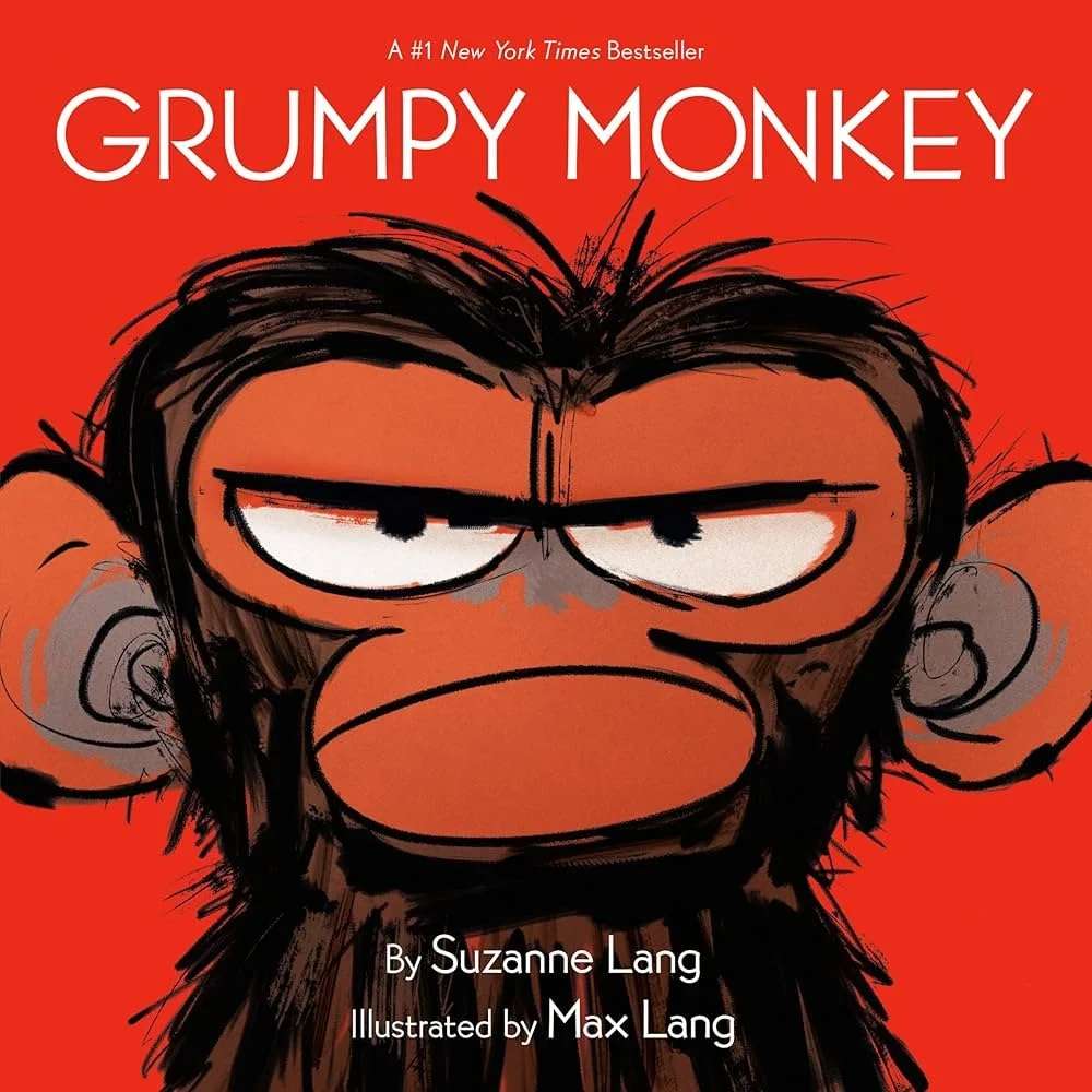Book cover of 'Grumpy Monkey' featuring an illustration of an annoyed-looking monkey with dark hair and eyebrows, set against a red background.