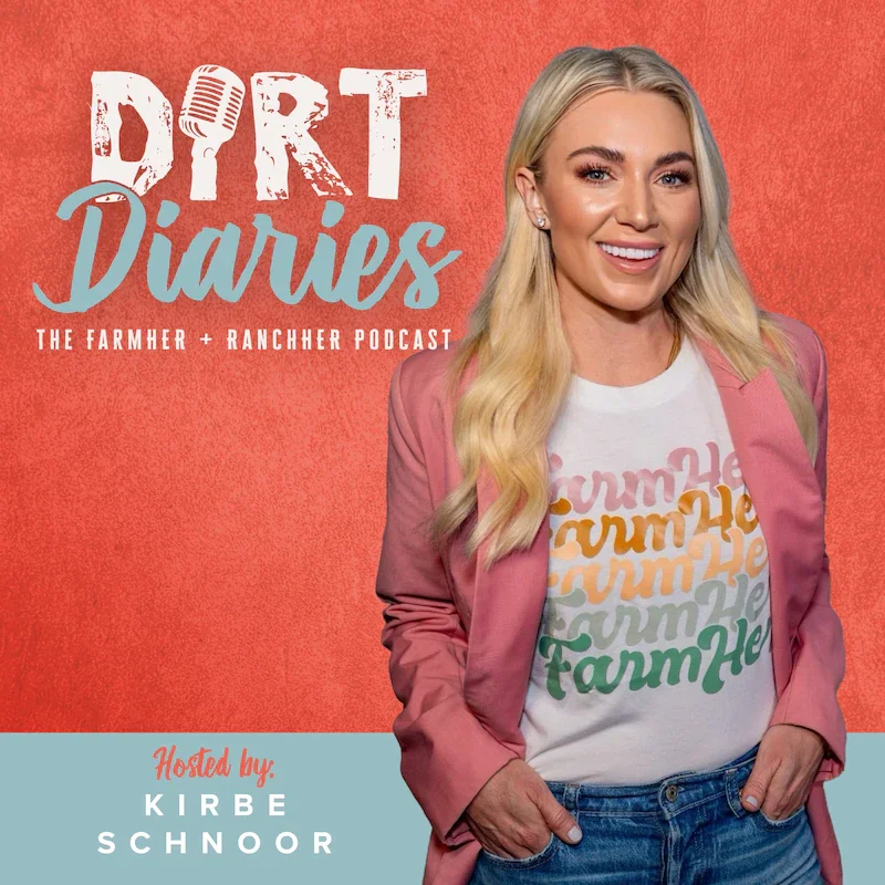 The image features a woman with long blonde hair, wearing a white T-shirt with a colorful repeated 'FarmHer' text design, paired with a pink blazer and blue jeans. The background is red, and the text on the image reads 'Dirt Diaries: The Farmer + Rancher Podcast' hosted by Kirbe Schnoor.