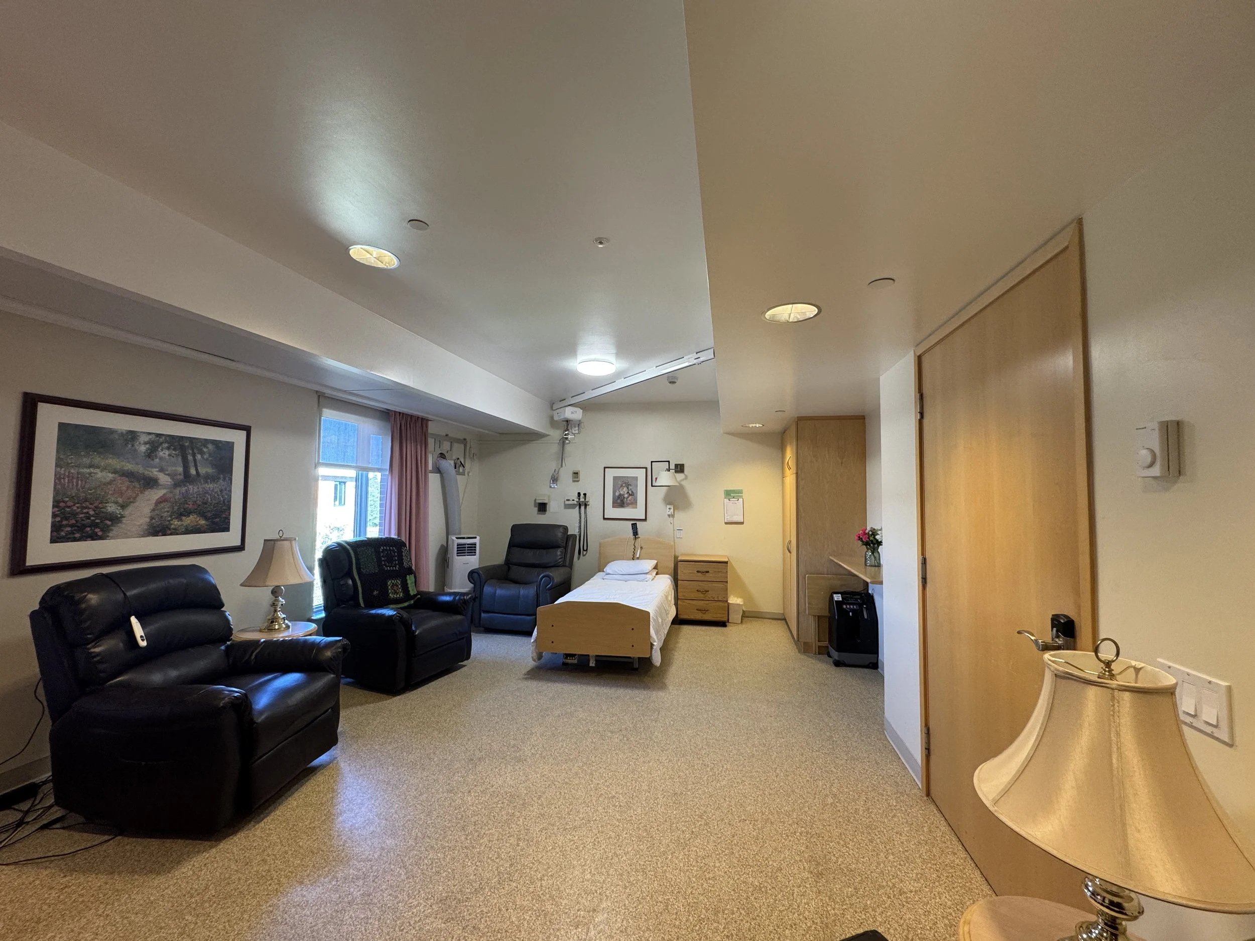 Serenity Room: A quiet and private end-of-life family room designed to provide comfort and support for residents and their loved ones during their final days. The room features comfortable reclining chairs where family members can rest and stay close