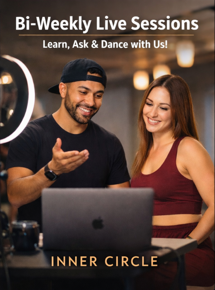 A man and woman smiling and looking at a laptop screen during a bi-weekly live session at Inner Circle, with the woman wearing a maroon crop top and the man wearing a black shirt and cap.