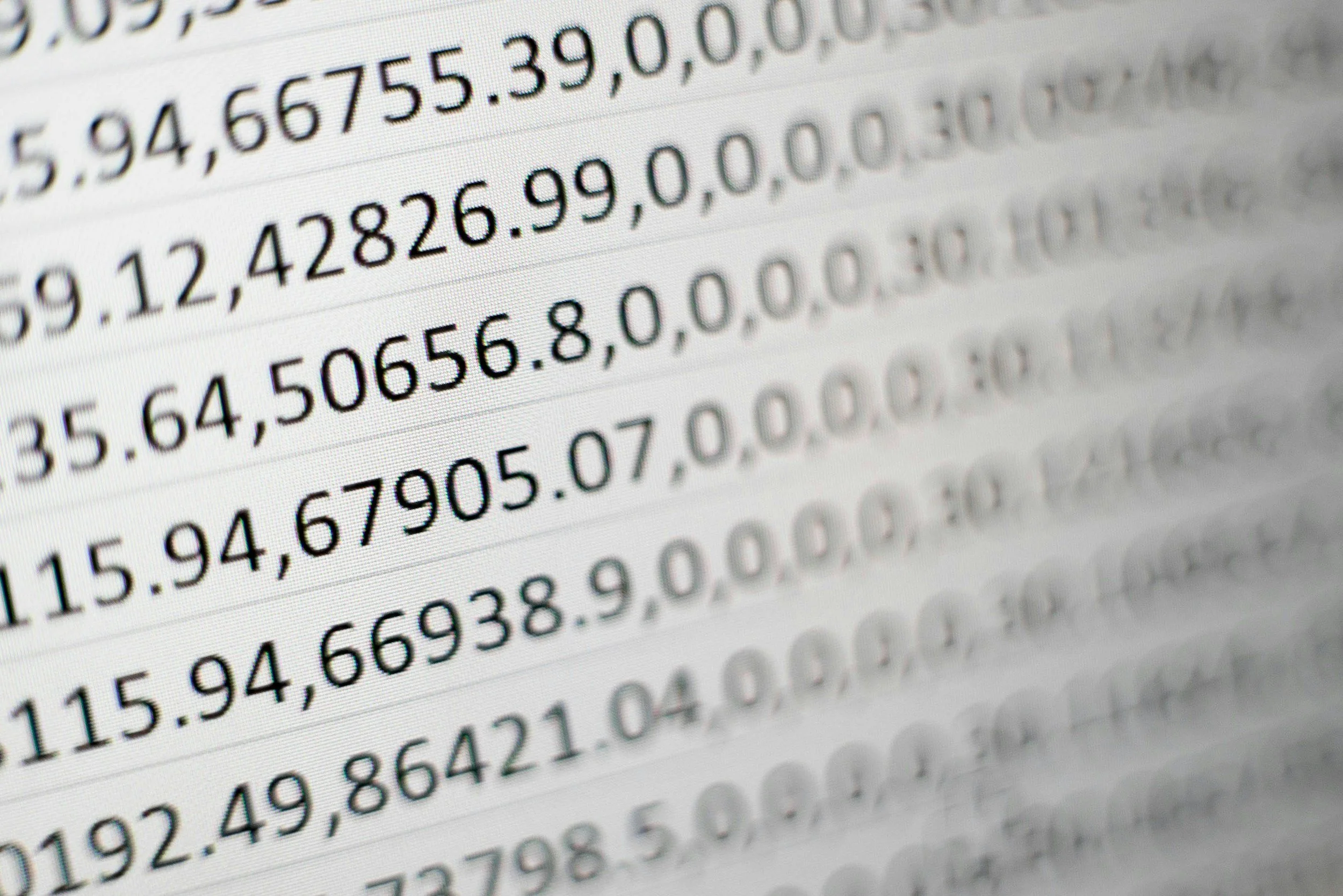 Close-up of a computer screen displaying rows of numerical data in a spreadsheet or data table, with numbers separated by commas and decimal points.