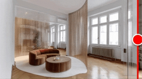 Modern living room with large windows, wooden floors, beige curtains, curved brown sofa, round coffee table, and white area rug.
