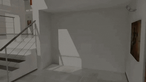 Empty room with stairs and a wall with a painting.