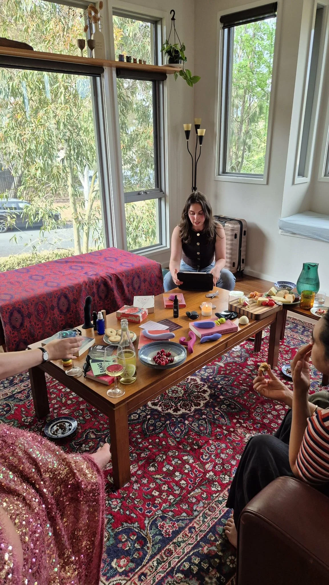 Eleni Gabrielides hosting a Flossy soirée in Canberra, guiding participants through a pleasure-centred educational experience with sex toys and open discussion.