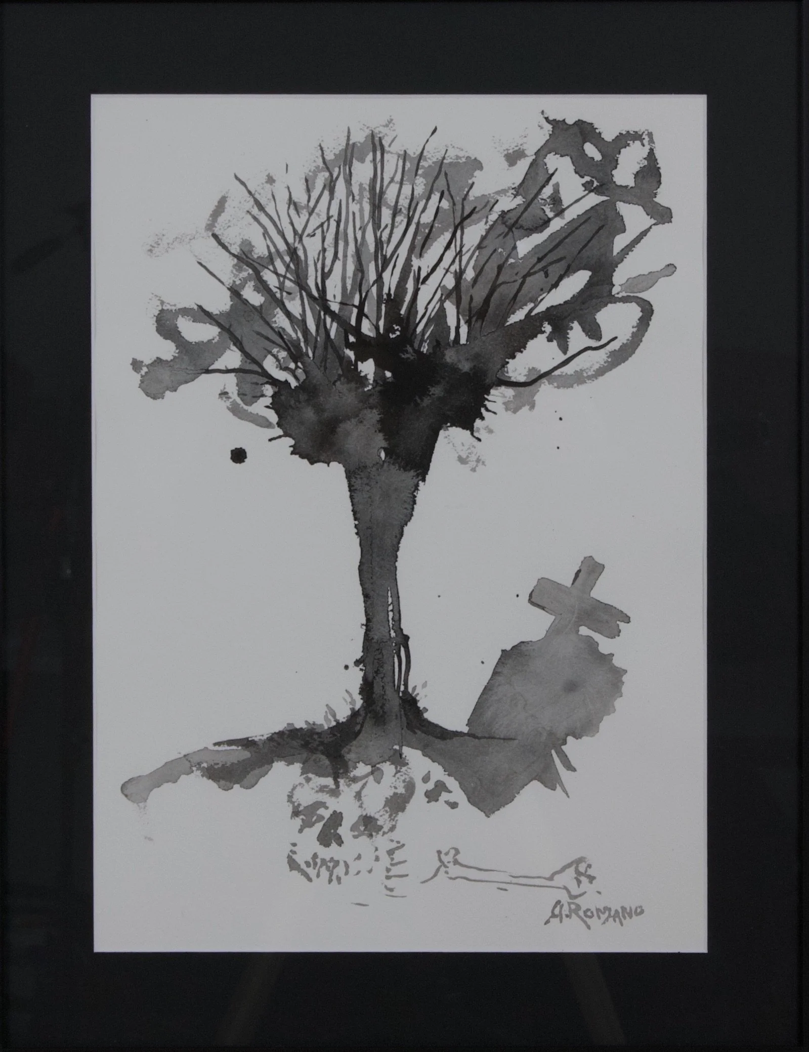 White paper with a black tree and graveyard