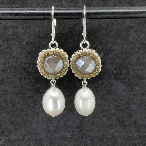 Pair of earrings designed by SirlinHallJewelry.com with a moonstone gemstone top and hanging large white freshwater pearls