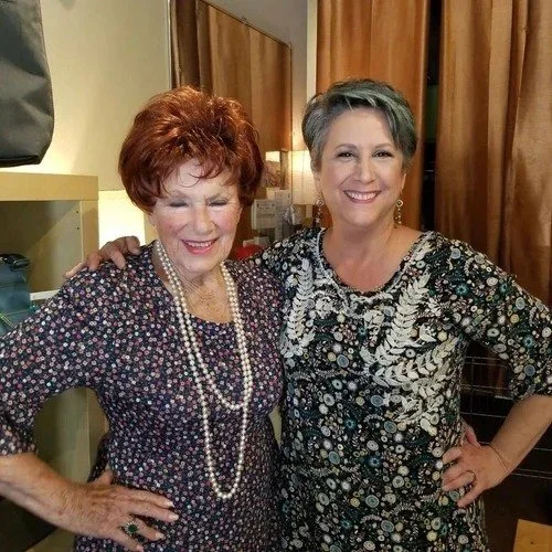 Artist Lisa Sirlin Hall (on right) alongside Marion Ross who is wearing her 90-inch pearls restrung by Lisa.  They are standing in Lisa's former jewelry Gallery No Roses in Sherman Oaks, CA