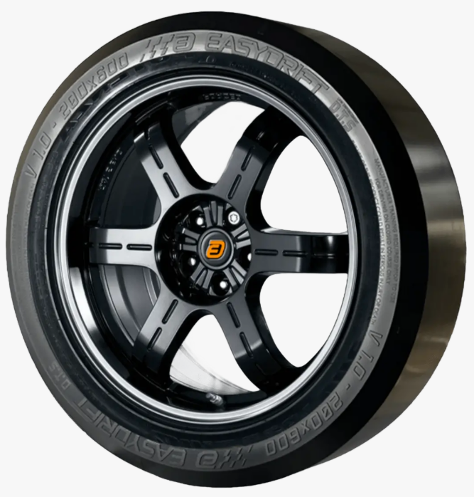Close-up of a the Easydrift product installed on a car tire mounted on a black alloy wheel with five spokes, featuring brand and size markings on the sidewall, such as "Pirelli" and "Velo Pirelli".