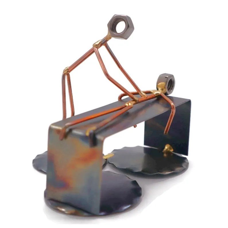 Sculpture made of metal parts resembling a person giving a massage.