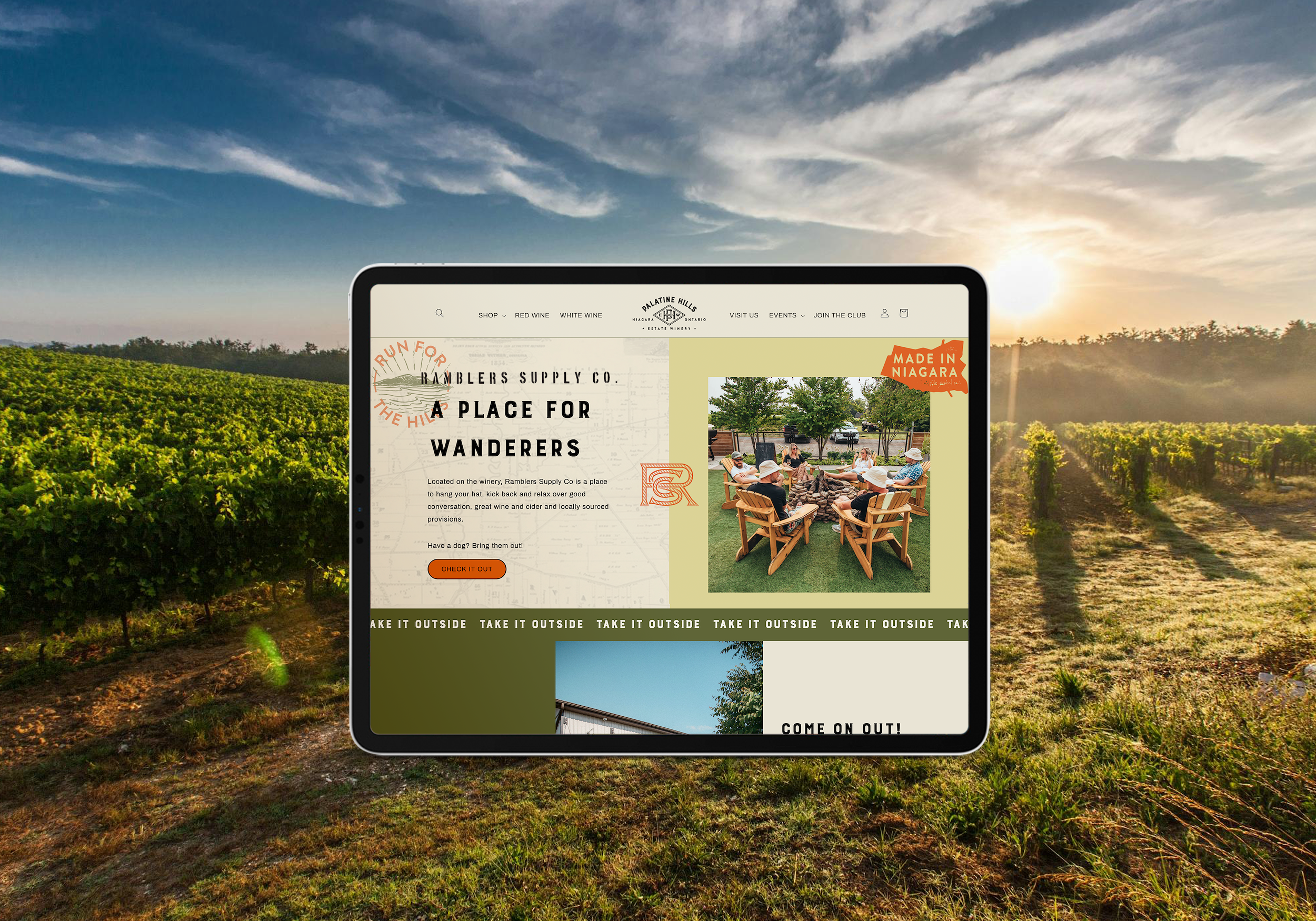 A website displayed on a tablet surrounded by a vineyard landscape at sunset. The website is for Palatine Hills winery in Niagara, Ontario, featuring themes of wine and outdoor activities.