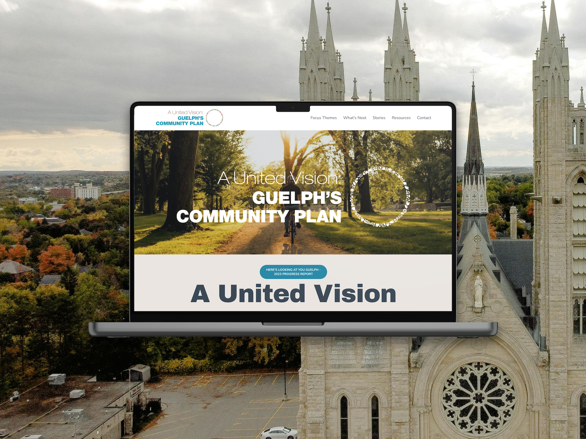 A laptop displays a community plan website with a scenic park and trees at sunset. The background shows a church with tall spires and a cityscape with buildings.