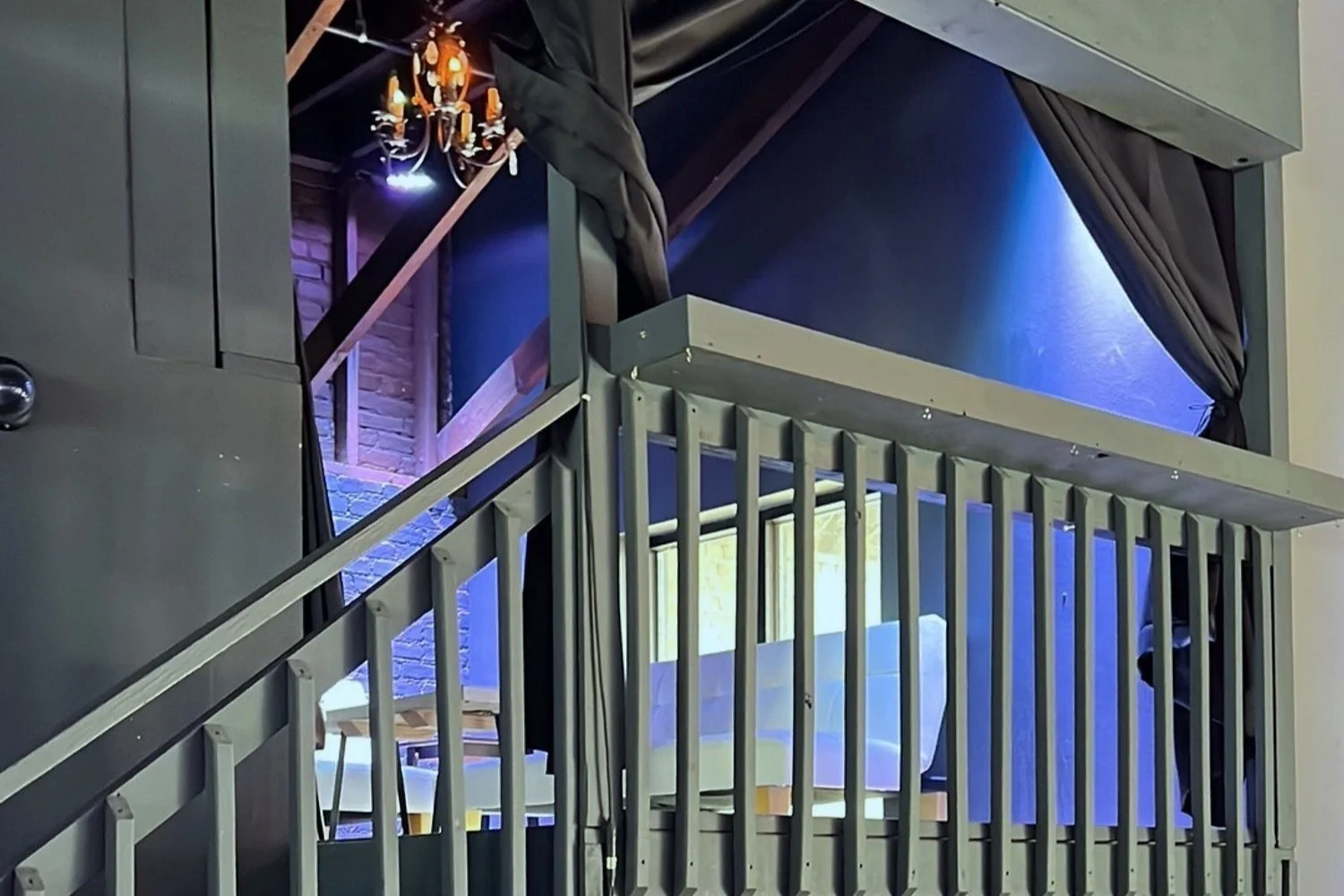 Industrial-style staircase with chandelier and modern lighting