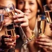 Group of people clinking champagne glasses at a celebration.