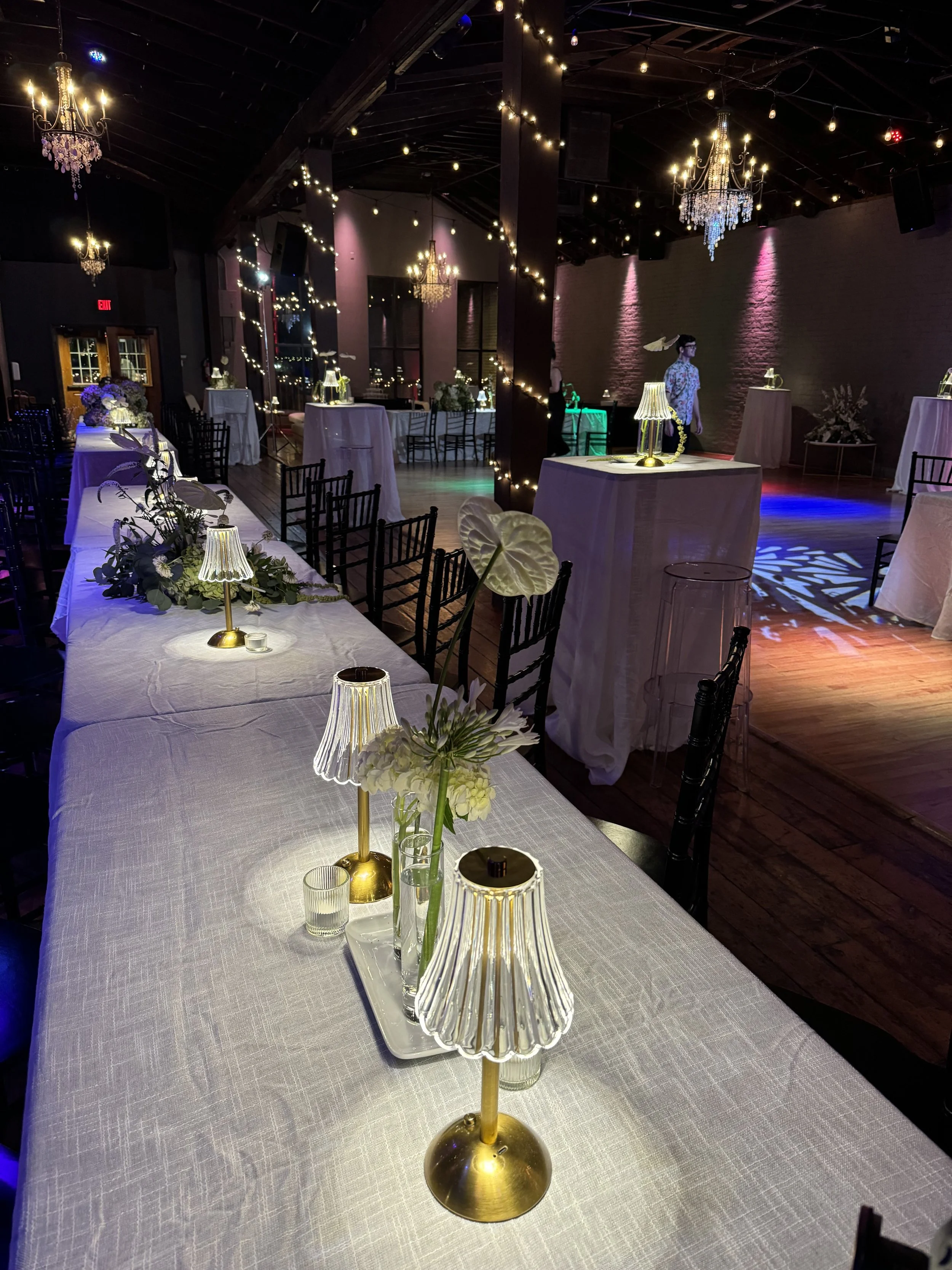 Wedding reception setup with white linens and chick ligths at Twenty Seven Event Venue in downtown Little Rock Arkansas 