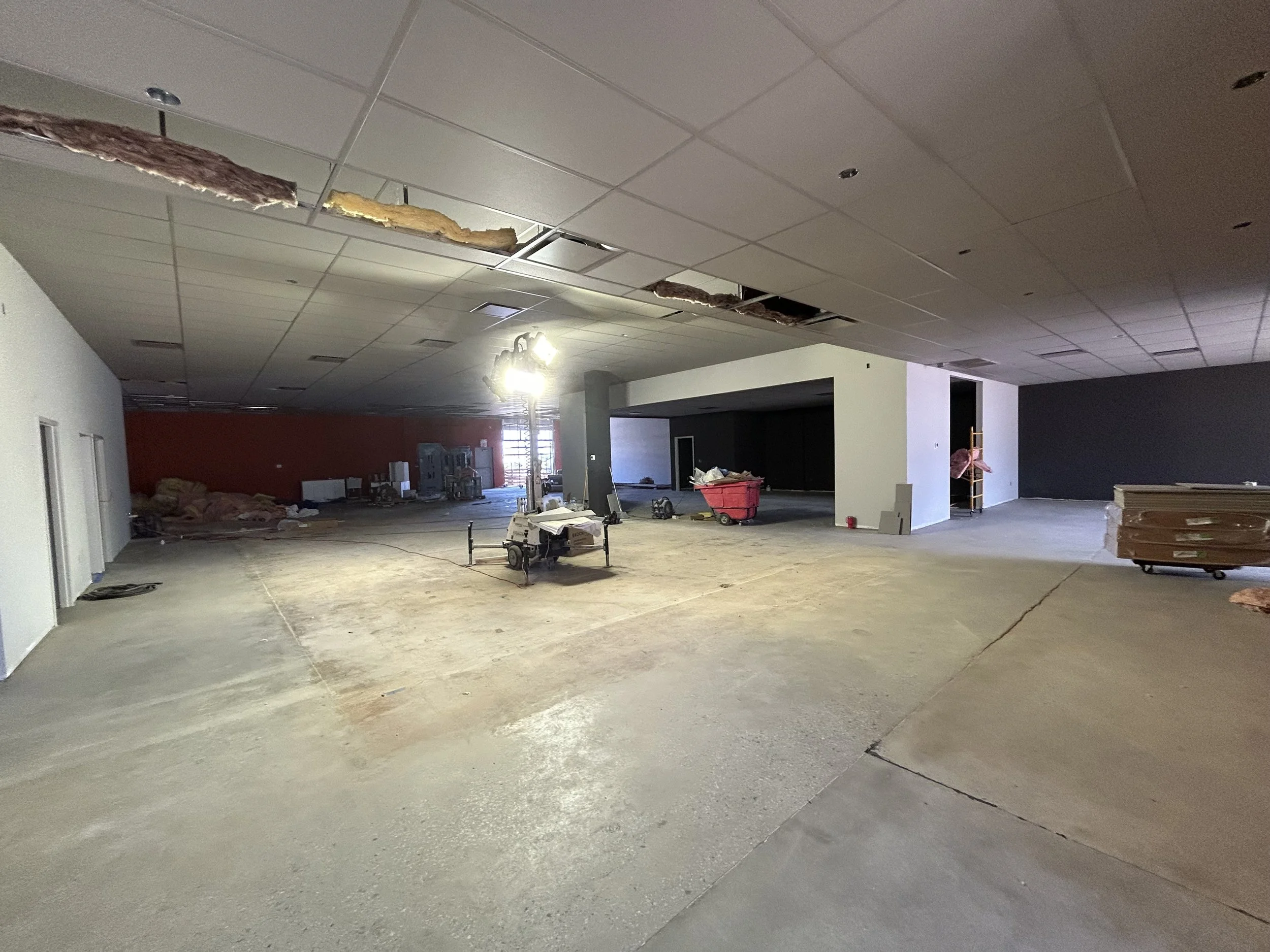 Crucible Fit interior during construction, with missing ceiling tiles and unfinished flooring.