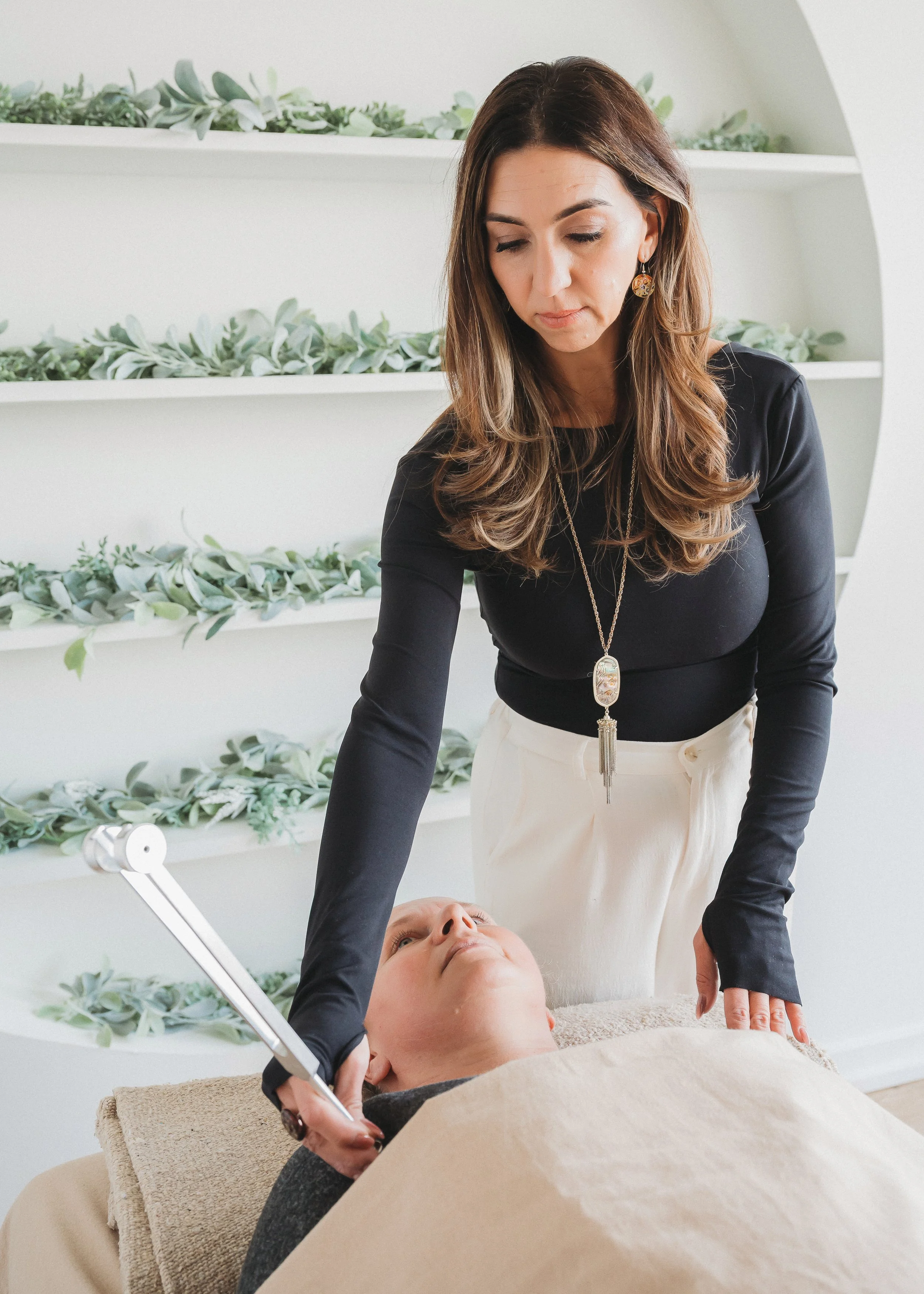 Amanda Gandolfo using tuning forks during an in-person Biofield Tuning session on Long Island, NY.