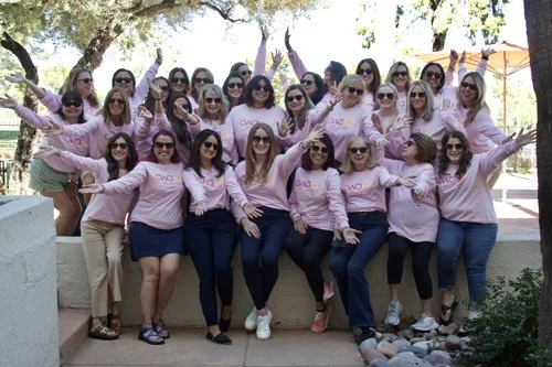 Women attending the 2025 Optical Women's Association retreat gathering outdoors for a group photo